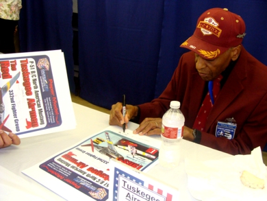 Dr. Coggs signing some posters.